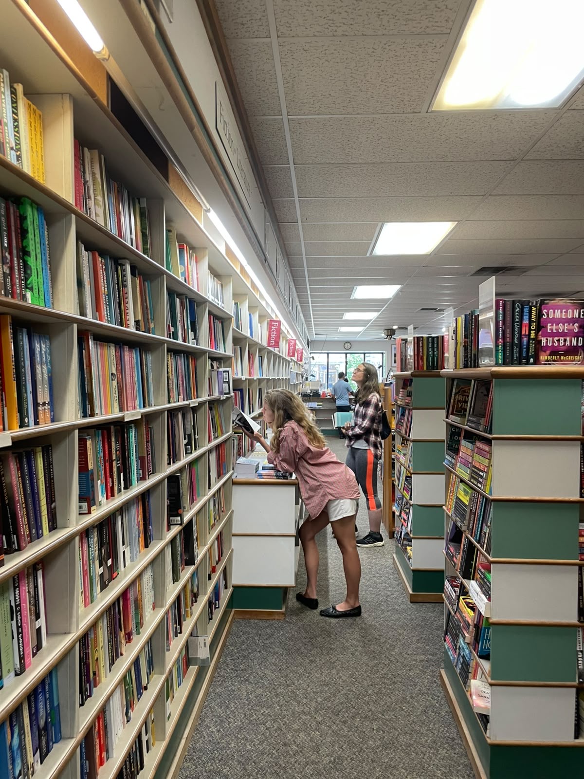 Browsing the fiction shelves in a bookshop